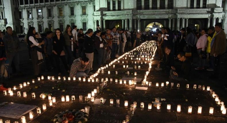 People take part in a protest at the Square of the Constitution in Guatemala City on March 9, 2017, following the death of 40 girls in a recent fire at a government-run children's shelter in San Jose Pinula, east of the capital