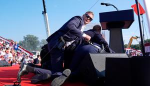 The US Secret Service shielding former President Donald Trump onstage at a Pennsylvania rally.Evan Vucci via AP
