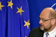 EP President Schulz looks at a european flag as he givesa statement after the conference of Presidents at the European Parliament in Brussels