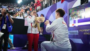 Badminton player Liu Yuchen proposes to gold medalist Huang Yaqiong after the medal ceremony following the Mixed Doubles Gold Medal Match on day seven of the Olympic GamesChina News Service/Getty Images