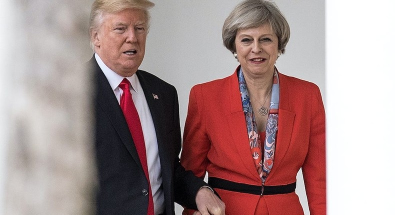 Former British Prime Minister Theresa May and former President Donald Trump walk along The Colonnade of the West Wing at The White House on January 27, 2017.