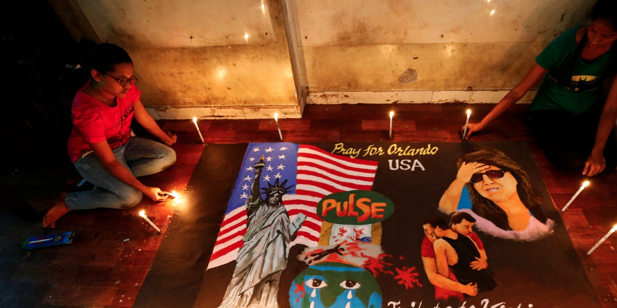 Students light candles around a rangoli, or mural made out of colored powders, inside an art institute in Mumbai, India.