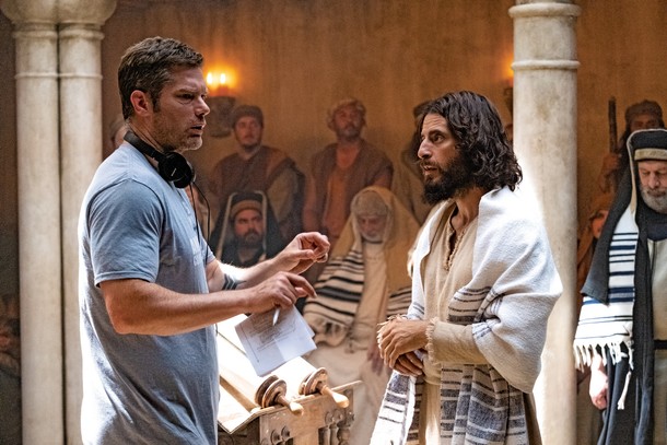 STARS OF THE CHRISTIAN SCREEN Creator and director Dallas Jenkins and star Jonathan Roumie on the set of The Chosen; and Jesus and the disciples in a scene from the series, which has garnered more than 110 million viewers worldwide.