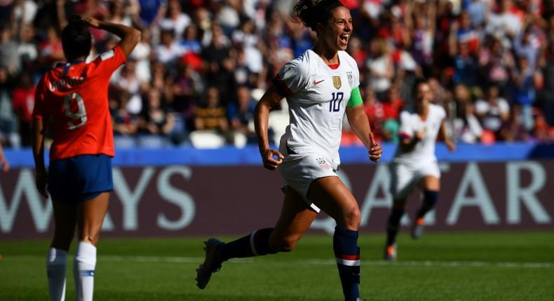 Carli Lloyd scored twice and missed a penalty as the USA eased to a 3-0 win over Chile to qualify for the last 16 of the World Cup