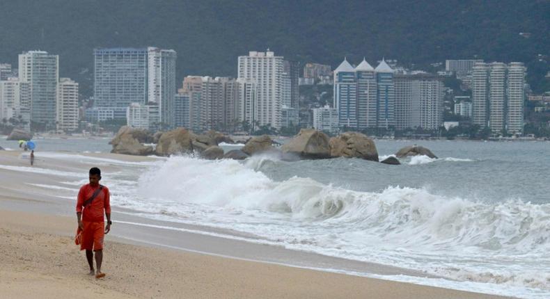 A lifeguard walks along the beach in Acapulco, Mexico on September 18, ahead of Lorena's expected arrival