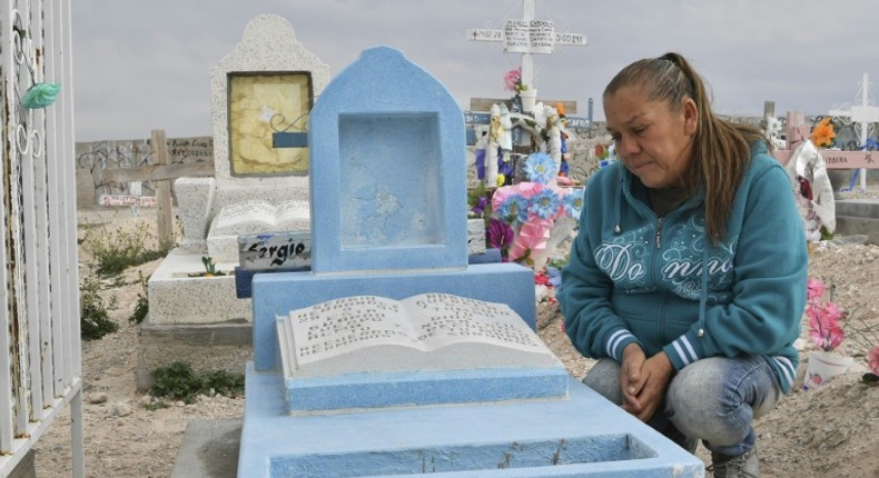 Maria Guadalupe Guereca beside the tomb of her son Sergio Hernandez who was killed in a cross-border shooting by a US border patrol agent