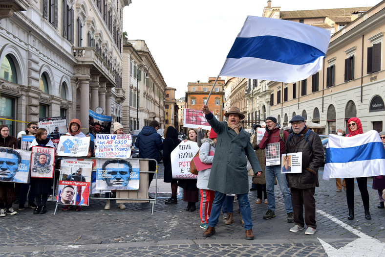 Aktywiści społeczności rosyjskiej we Włoszech z transparentami przeciwko Putinowi i biało niebieską flagą - symbolem protestu Rosjan przeciwko wojnie - demonstrujący na rzecz wolności Aleksieja Nawalnego i wszystkich rosyjskich więźniów politycznych, 21 stycznia 2023 r.