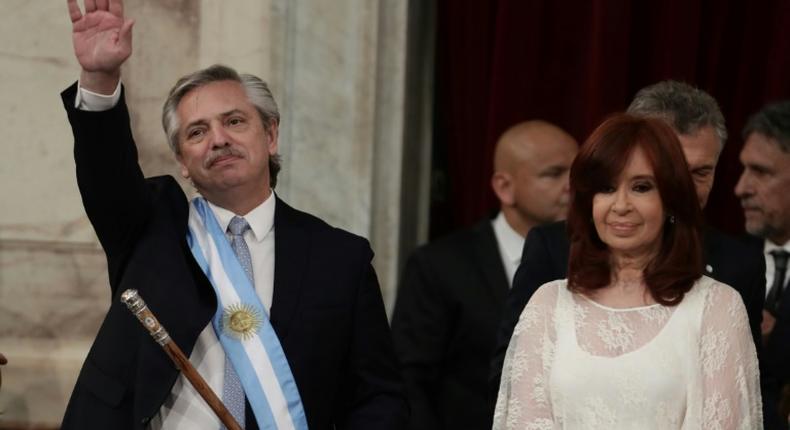 Argentina's new president, Alberto Fernandez, waves next to his vice-president Cristina Fernandez de Kirchner, after receiving the presidential sash from outgoing leader Mauricio Macri