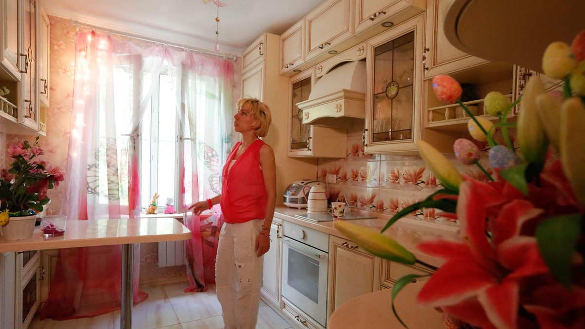 Anti-demolition activist Kari Guggenberger shows the kitchen of her apartment in a building to be de