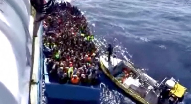 A boat full of migrants is seen next to Swedish ship Poseidon during a rescue operation in the sea off the coast of Libya in this still image taken from an August 26, 2015 video. REUTERS/Swedish Coast Guard Handout via Reuters TV