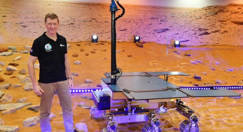 British astronaut Tim Peake poses with a working prototype of the Rosalind Franklin ExoMars Rover