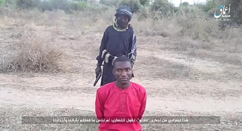 Daciya Dalep, a university student, on his knees moments before he was executed by a Boko Haram terrorist [Amaq News]