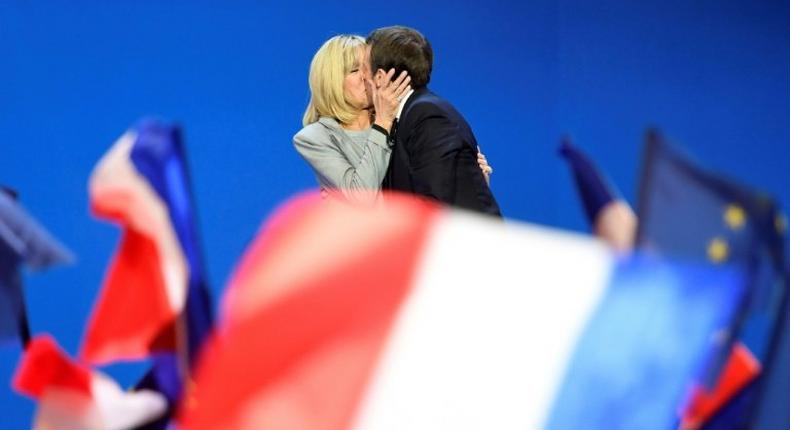 France's incoming president Emmanuel Macron kisses his wife Brigitte after his victory in the first round of the election in April
