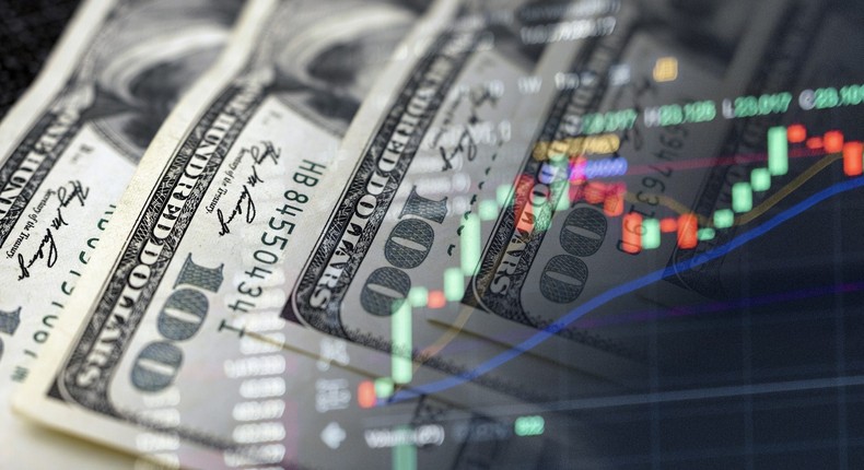 Cash dollars and stock market indicators (inflation, economy, crisis, finance)Getty Images