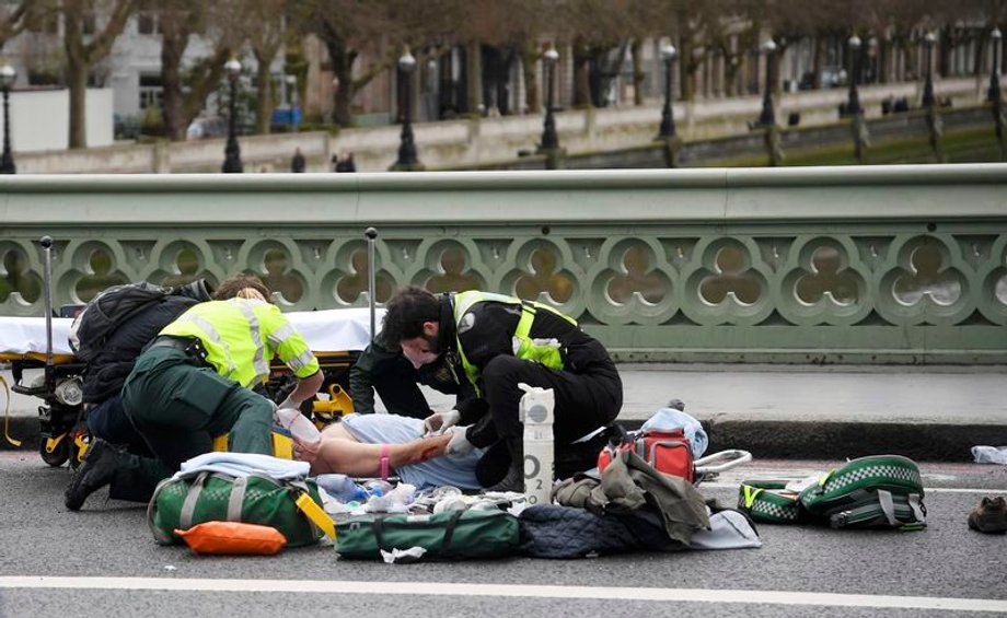 Paramedics treat an inured person after an incident on Westminster Bridge in London