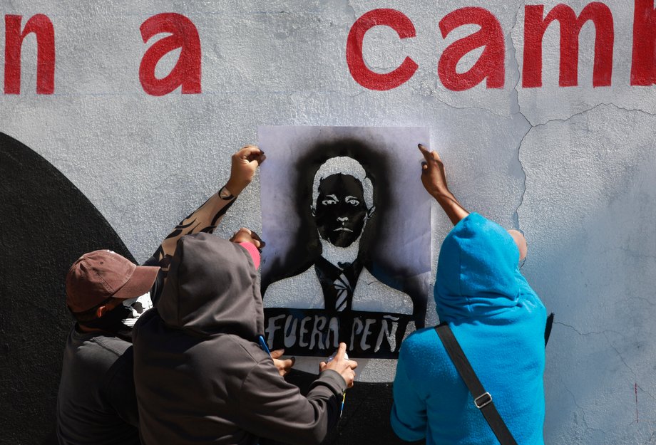 Demonstrators stencil graffiti during a demonstration for the 43 missing Ayotzinapa students, in Chilpancingo, in Guerrero, November 20, 2014. The graffiti "Fuera Pena" reads as "out of here Pena," referring to Mexico's President Enrique Pena Nieto.