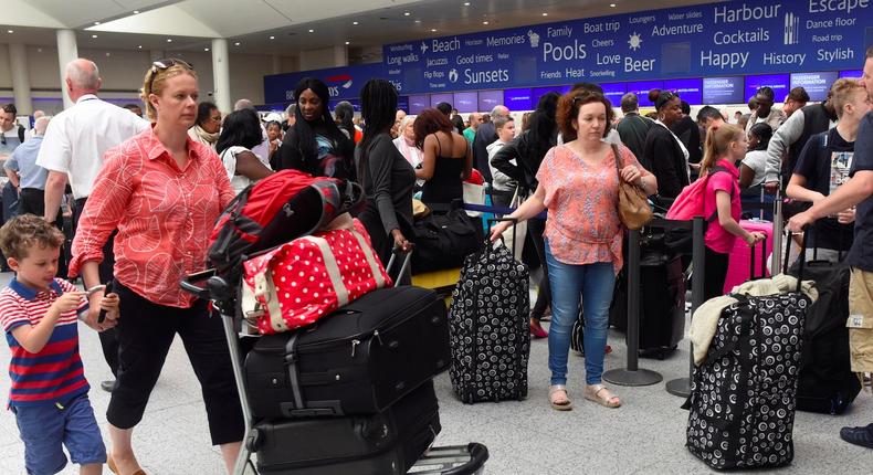 People queue with their luggage for the British Airways check-in desk at Gatwick Airport in southern England, Britain, May 28, 2017.