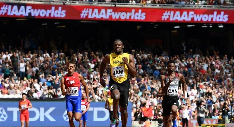 Jamaica's Usain Bolt (C) race to victory on the anchor leg ahead of Canada's Mobolade Ajomale (R) and Cuba's Jose Luis Gaspar to win their heat in the 4x100m relay at the IAAF World Championships at the London Stadium in London, on August 12, 2017