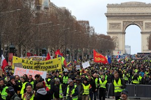 Protesters wearing yellow vests take part in a demonstration by the yellow vests movement in Paris