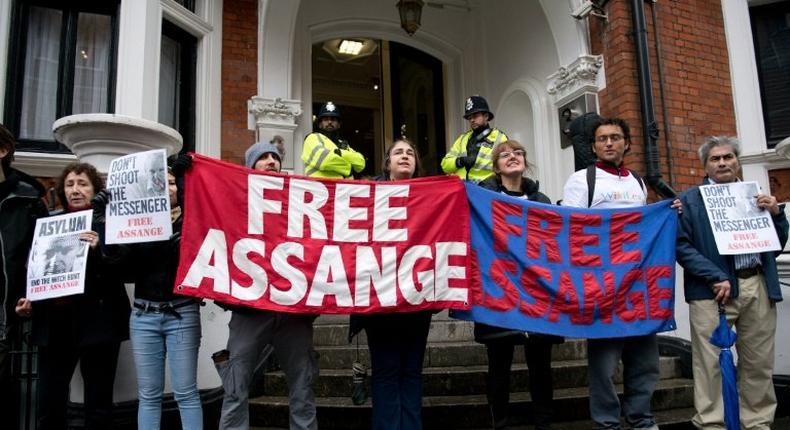 Protesters hold banners that read Free Assange outside the Ecuadorian Embassy in London on November 14, 2016