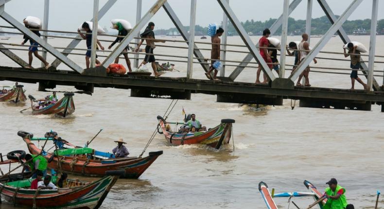 People from Dala township arrive in Yangon by boat after crossing the river