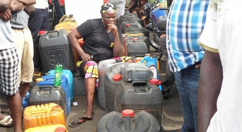 A woman waits in a queue in Lagos, a dejected look on her face as she mulls over the fuel crises.