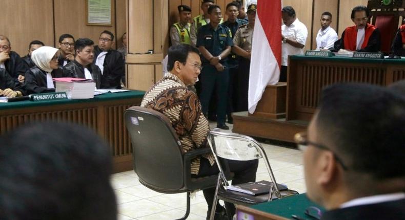 Jakarta Governor Basuki Tjahaja Purnama (C), is accused of insulting the Koran