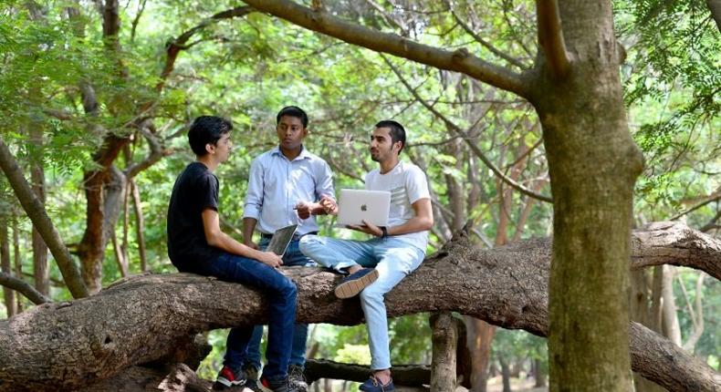 Ethical hackers Anand Prakash (R), Shashank (L), and Rohit Raj (C), who break into computer networks to expose rather than exploit weaknesses, meet at a public park in Bangalore