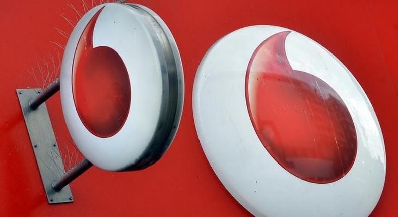 Vodafone branding is seen outside a retail store in London, file. 