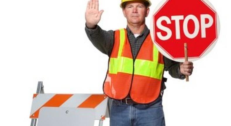 Traffic official flagging approaching car