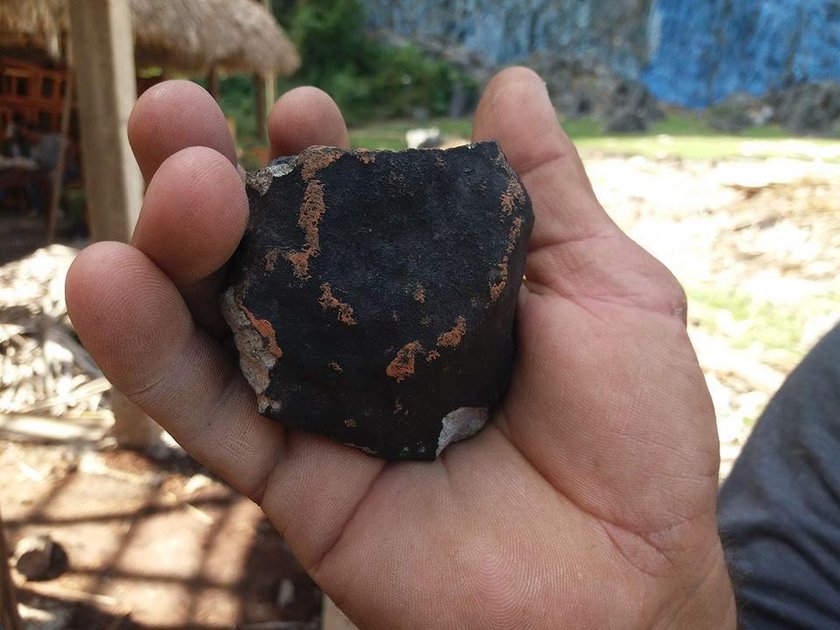 A man guides oxen in a farm at the area where a meteorite was reported to land yesterday, in Vinales