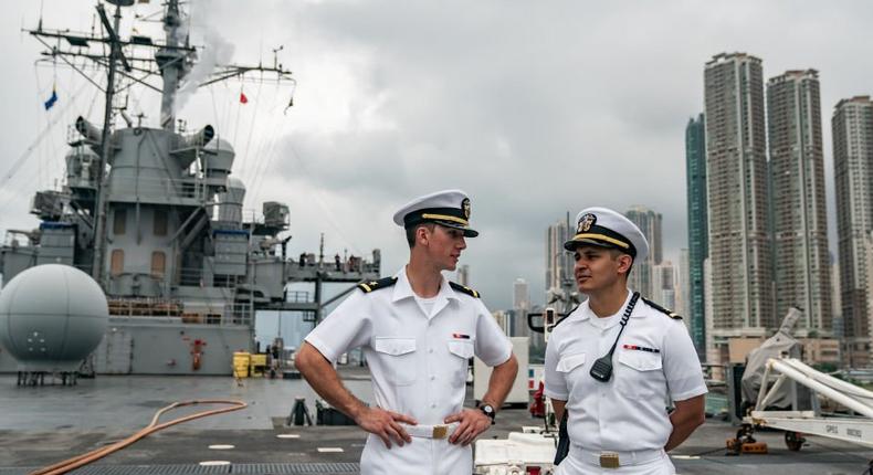 Navy crew members stand on deck of the USS Blue Ridge during a port call on April 20, 2019 in Hong Kong, China.