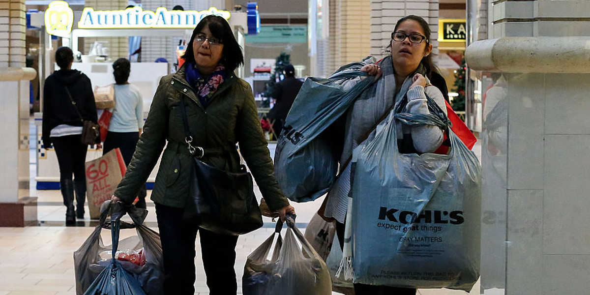 Customers carry shopping bags at the Newport Mall during Black Friday Sales on November 27, 2015 in Jersey City, New Jersey. It was expected that 135.8 million Americans would shop this Black Friday weekend, according to the National Retail Federation.