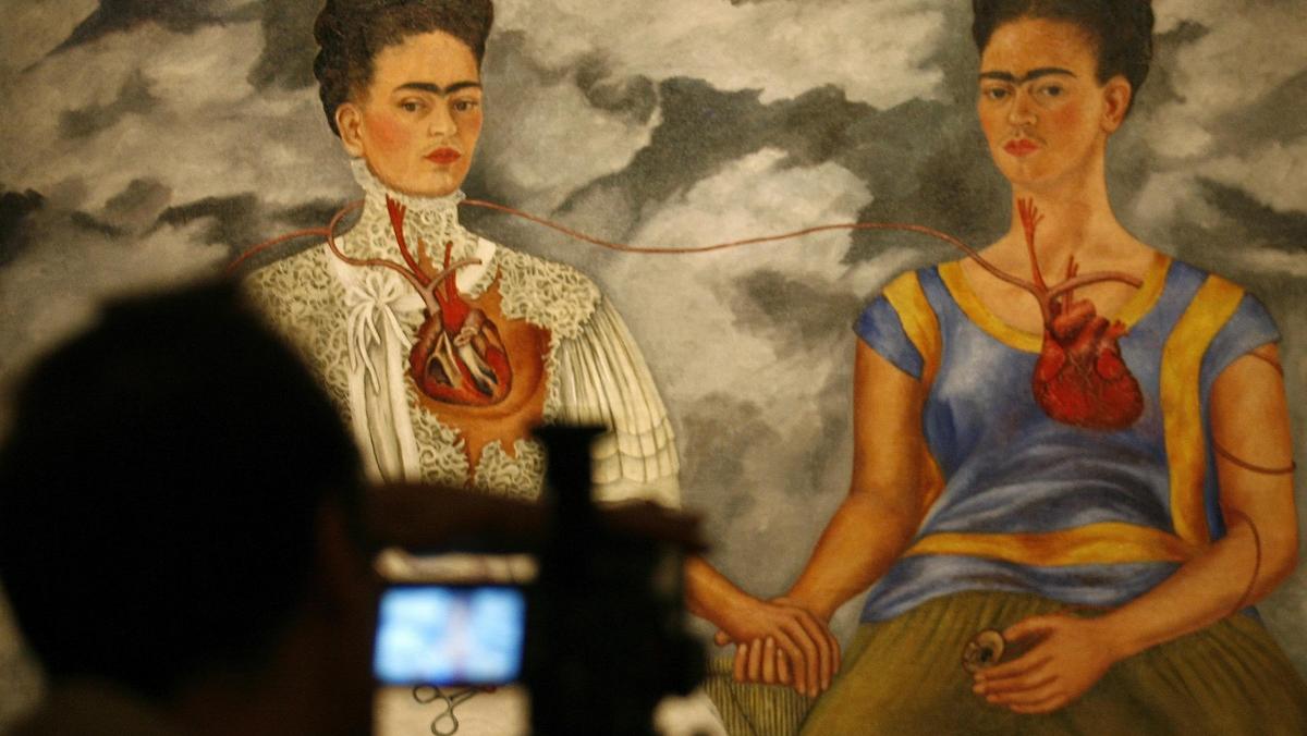 Cameraman films Frida Kahlos painting at Mexico City's Bellas Artes museum