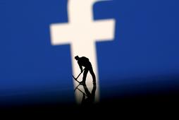 FILE PHOTO: A figurine is seen in front of the Facebook logo in this illustration