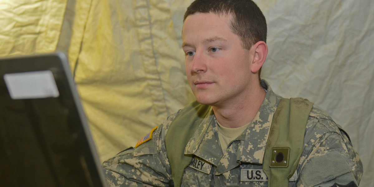 US Army Cpl. Charles Wamsley, a communication specialist, works on a computer at the National Training Center, Fort Irwin, California, January 20, 2014.