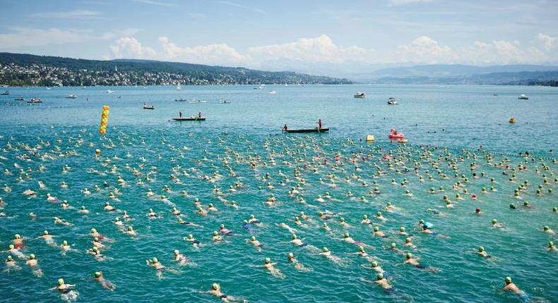 Swimmers leave the start of the annual Lake Zurich crossing swimming event in Zurich on July 5, 2017, where a swimmer reportedly drowned during the race