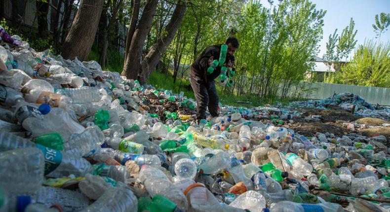 A waste worker in Srinagar, India sorts and collects plastic for recycling.LightRocket/Getty Images
