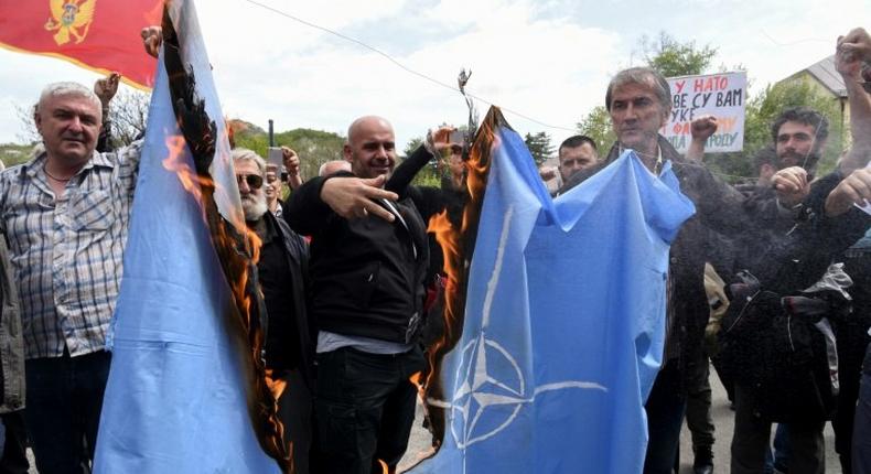 Protesters burn the NATO flag on April 28 during a demonstration against Montenegro's accession to the Western military bloc