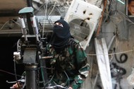 A female member of the Ahbab Al-Mustafa Battalion stands on a pick-up truck mounted with an anti-air