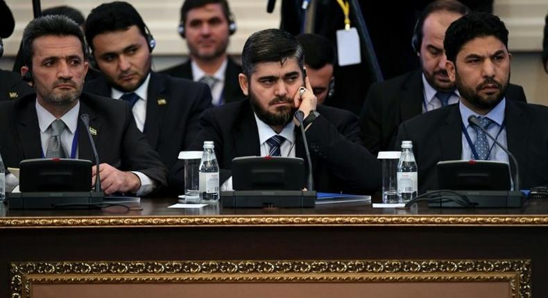 Chief opposition negotiator Mohammad Alloush (C) of the Jaish al-Islam (Army of Islam) rebel group attends the first session of Syria peace talks at Astana's Rixos President Hotel on January 23, 2017