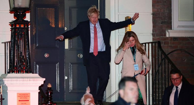 Britain's Prime Minister Boris Johnson and his girlfriend Carrie Symonds leave the Conservative Party's headquarters with their dog Dilyn following the general election in London, Britain December 13, 2019. REUTERS/Lisi Niesner