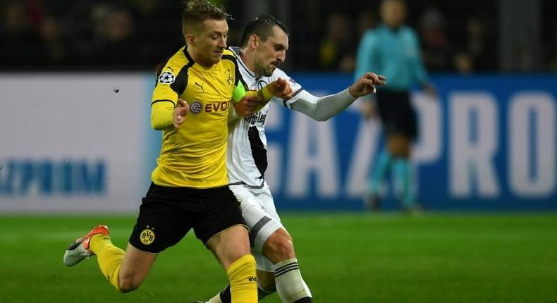 Marco Reus (left) is netted a hat-trick in Borussia Dortmund's record 8-4 hammering of Legia Warsaw