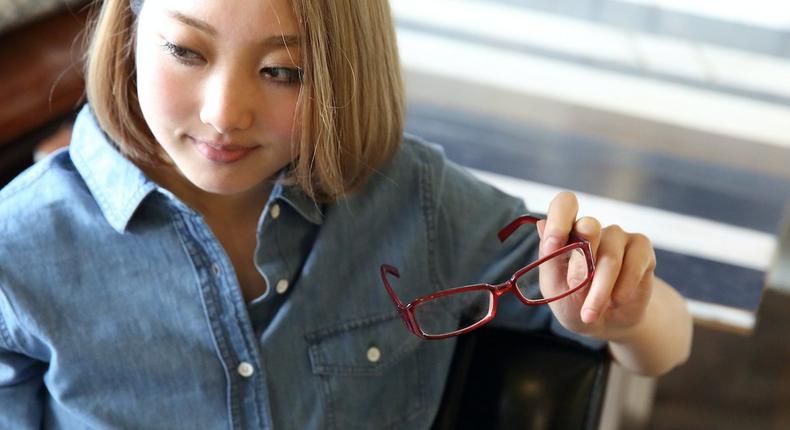 woman holding glasses