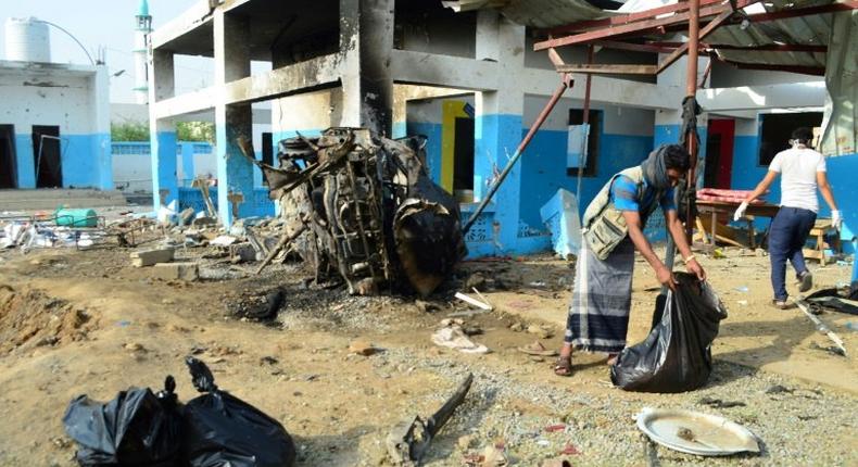 Yemeni workers clear debris at a hospital operated by the Doctors Without Borders on August 16, 2016 in Abs, a day after the hospital was hit by an air strike by the Saudi-led coalition