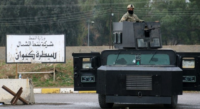 Masked Kurdish forces loyal to the Patriotic Union of Kurdistan (PUK) stand guard at the North Oil Company headquarters in the northern Kurdish-controlled city of Kirkuk on March 2, 2017