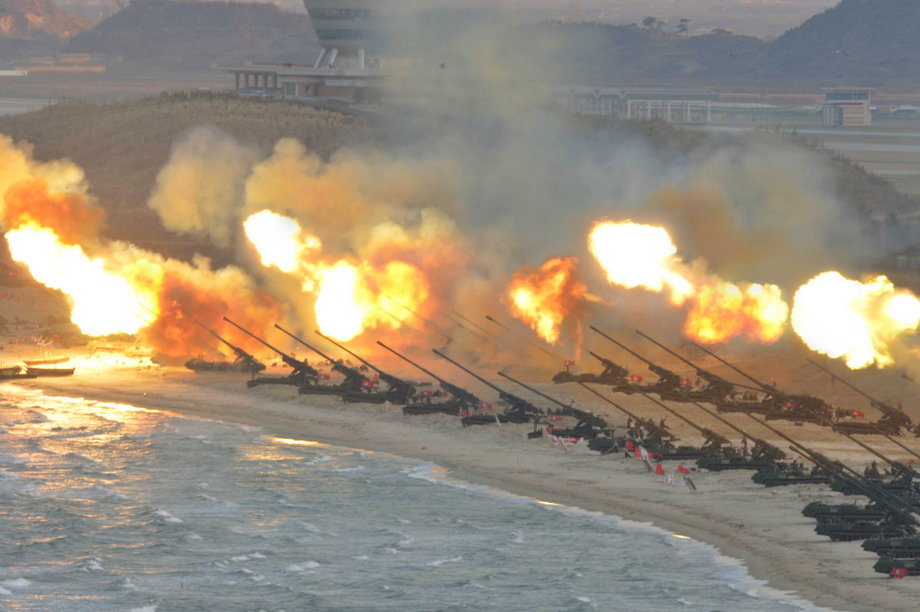 Artillery pieces are seen being fired during a military drill at an unknown location.