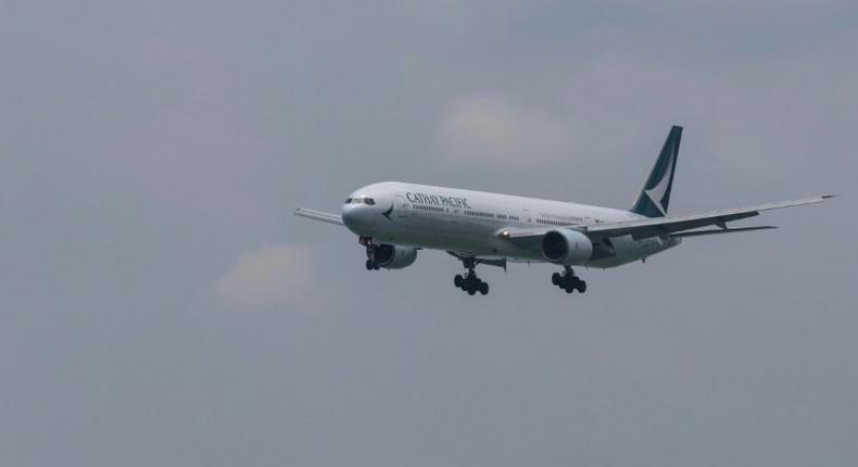 A Cathay Pacific passenger plane makes its descent before landing at Hong Kong's international airport on August 16, 2017