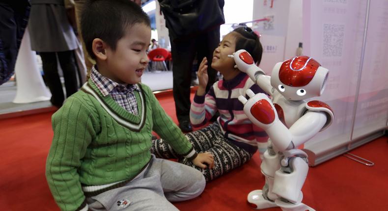 A Nao humanoid robot by Aldebaran Robotics dances to the Chinese song Little Apple at the World Robot Exhibition during the World Robot Conference in Beijing, China, November 24, 2015.