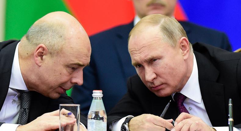 Russian President Vladimir Putin, right, and Finance Minister Anton Siluanov, left, face tricky decisions over the government's foreign bonds.